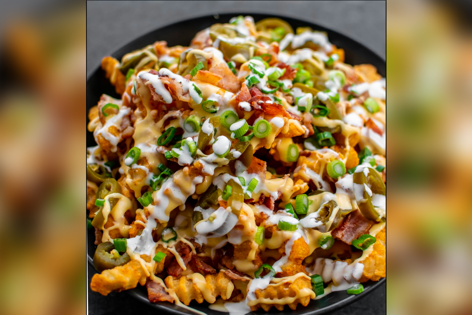 A plate of food with cheese, bacon and green onions.