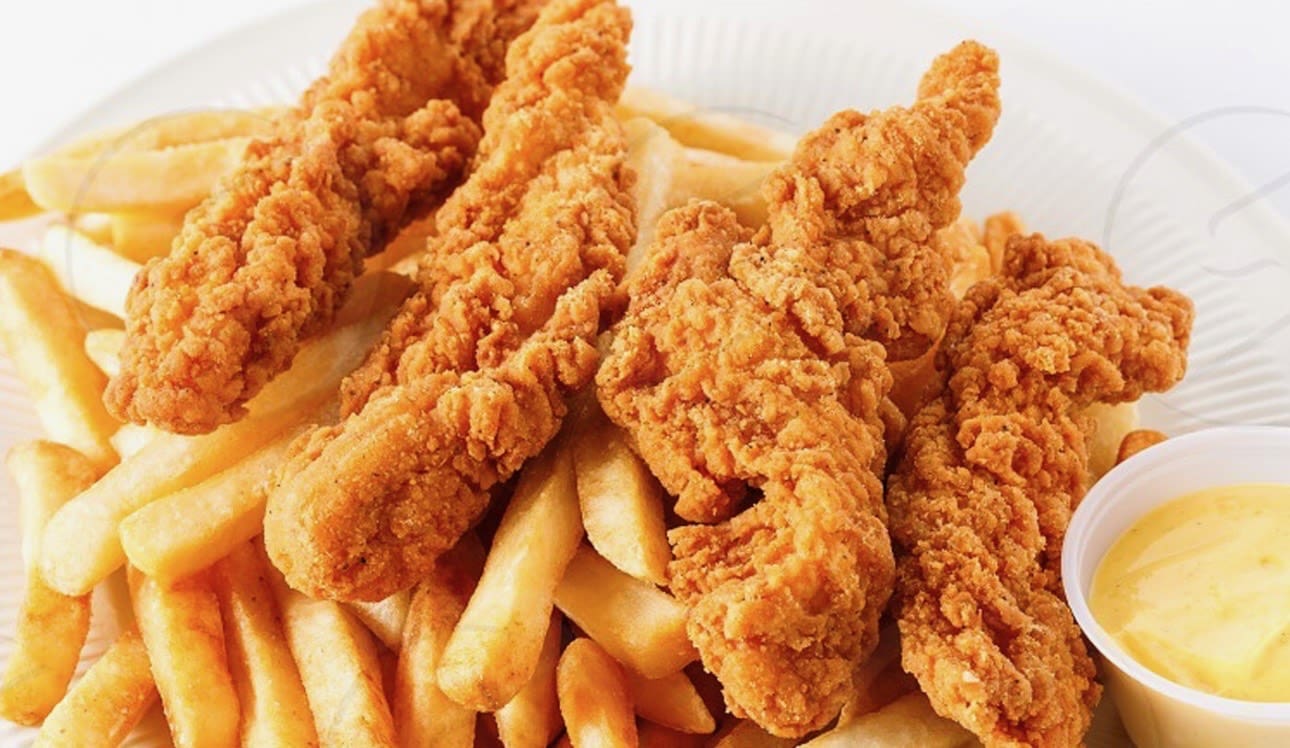 Crispy fried chicken tenders served with golden French fries.